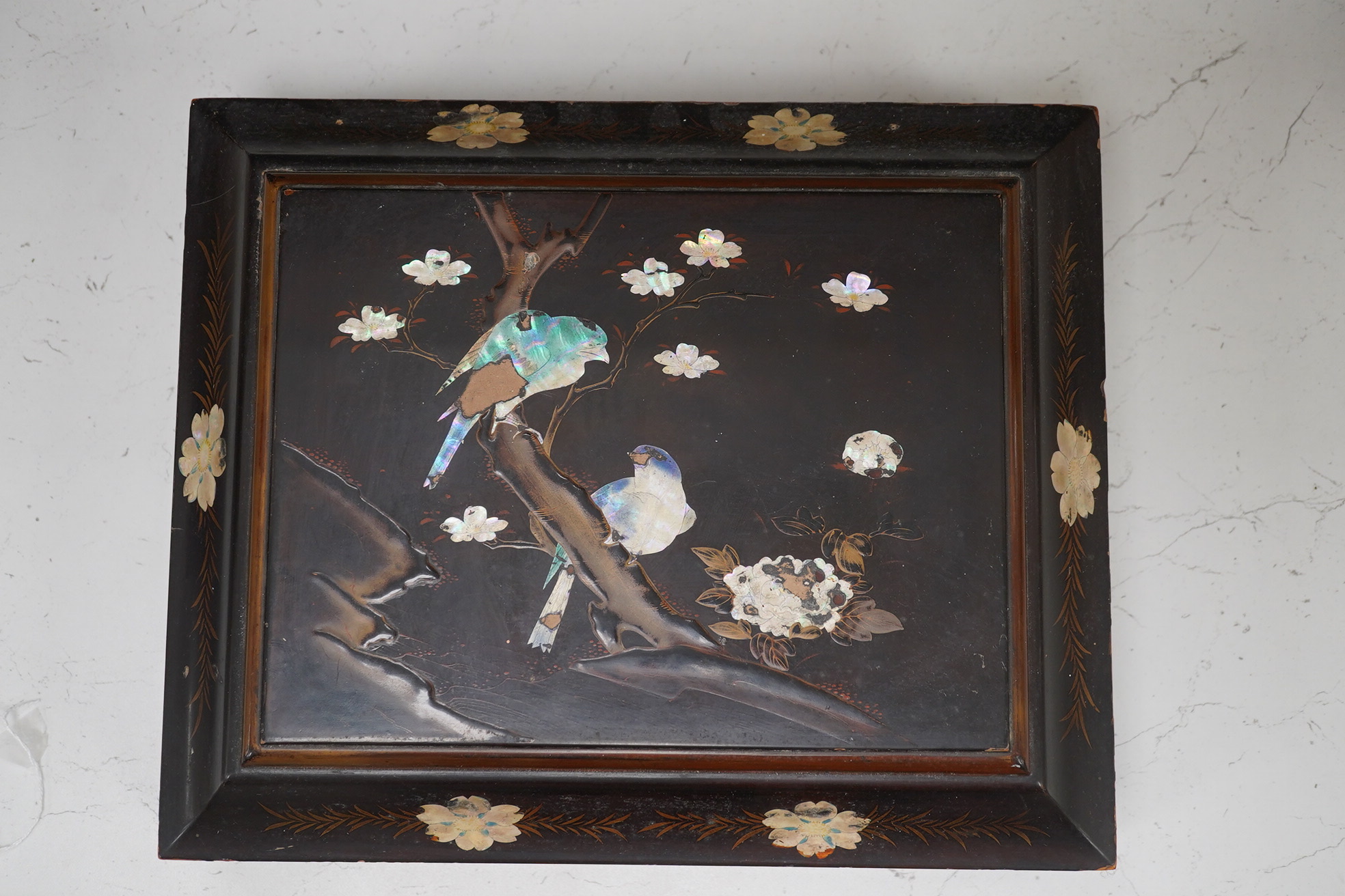 A Japanese lacquered box with mother of pearl inlay of birds and flowers, 35.5cm wide. Condition - worn on the outside to be expected, inside good